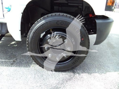 Truck wheel and front fender of a 2023 Chevrolet Silverado 6500HD with tire and hubcap visible.