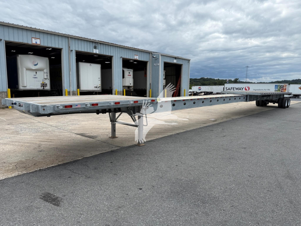 Flatbed trailer with extendable center section and truck cab at far right; visible on the side of the trailer is the Safeway Freight line. No specific model text readable.
