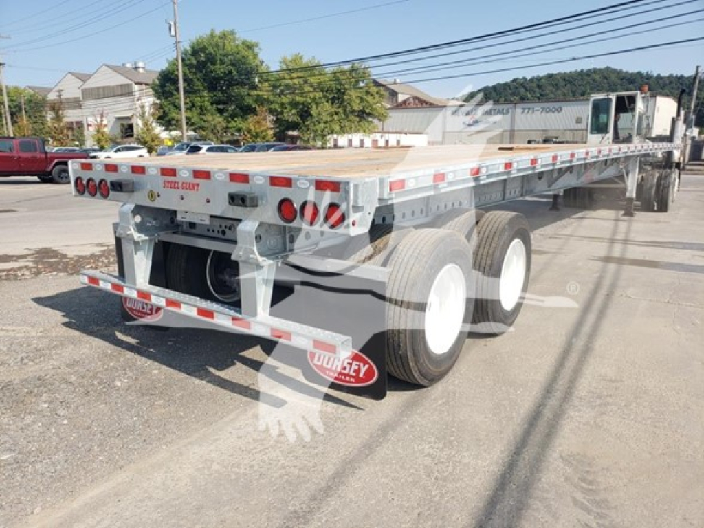 Flatbed trailer with galvanized steel deck and dual rear axles showing Dorsey branding and rear lights.