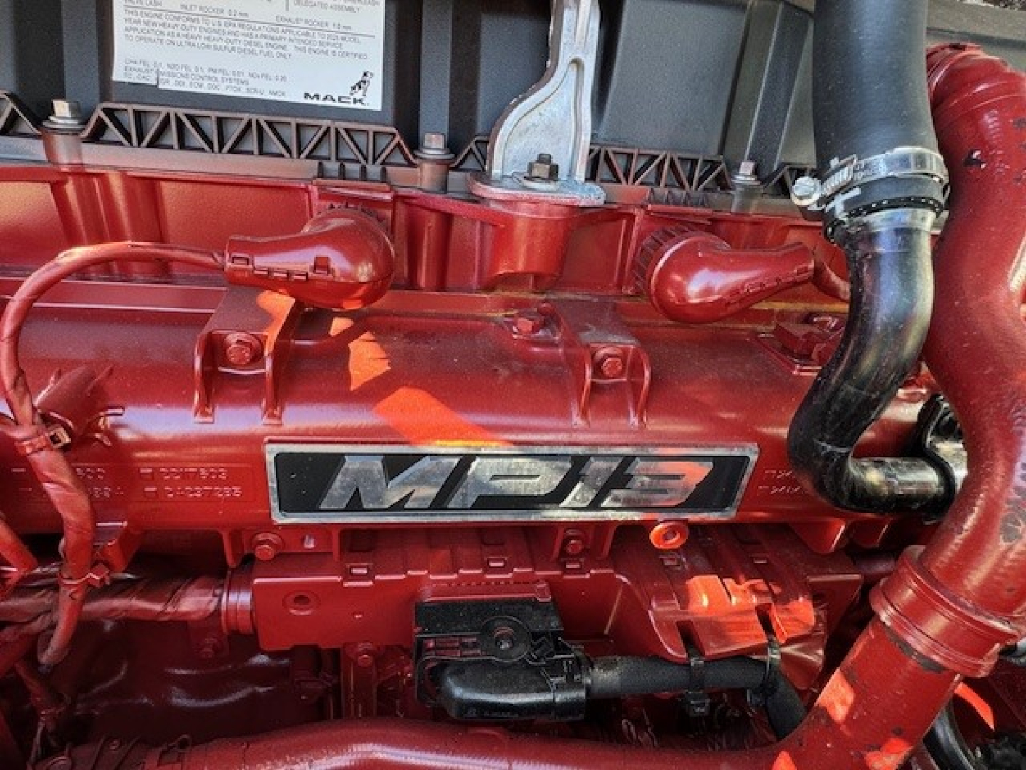 Mack MP13 engine bay with red engine cover and ‘MPI3’ badge visible.