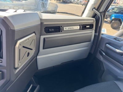 Pioneer dashboard badge on the Mack PR64T truck interior passenger side with stitched panels and vent, view from driver side door.