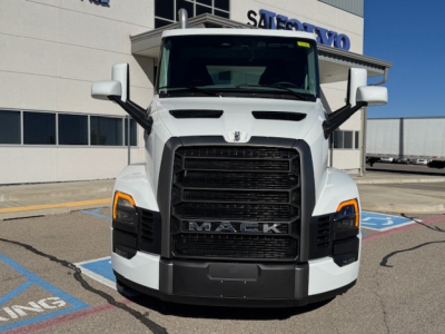 Mack PR64T truck front view showing chrome grille, black lower bumper, and large exterior mirrors.