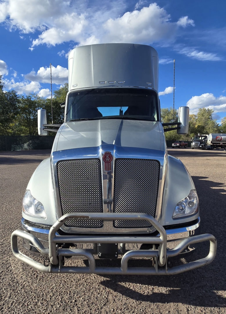 Kenworth T680 front view showing grille, bumper guard, and HD bull bar; clear blue chrome hood with Kenworth emblem and large mirrors.