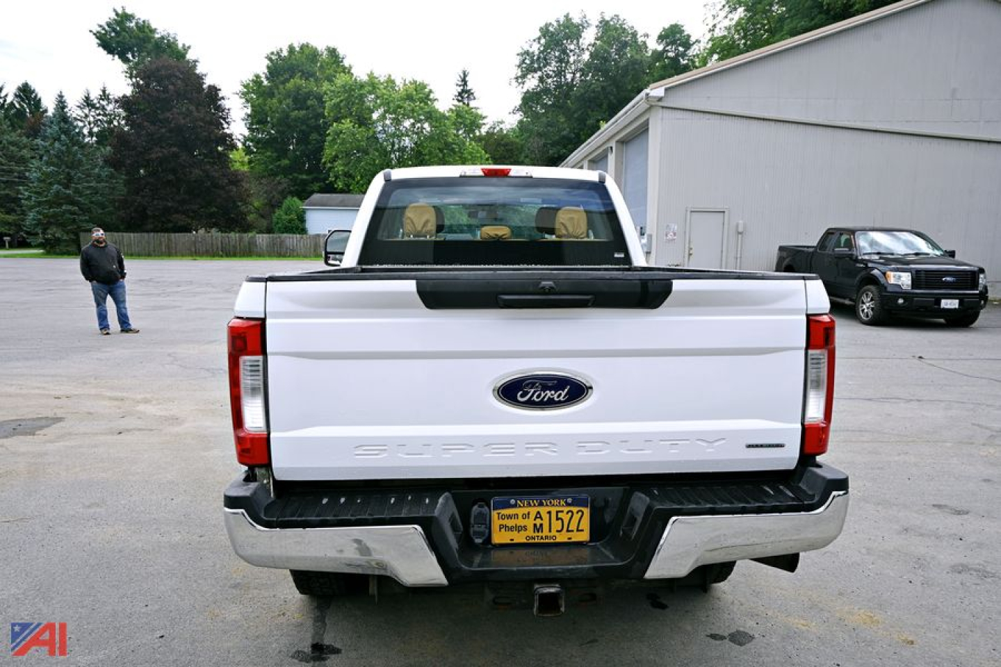 Ford F-350 Super Duty rear view showing tailgate with 'SUPER DUTY' lettering and rear bumper, yellow license plate, and Ford emblem.
