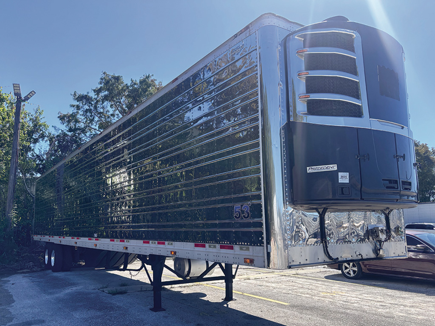 Wabash 2015 stainless steel reefer trailer side and front refrigeration unit visible.