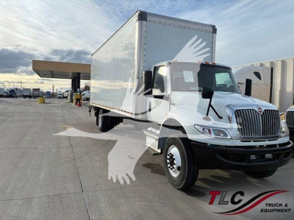 Truck cab andbox truck in a dealership lot with wings watermark across image.