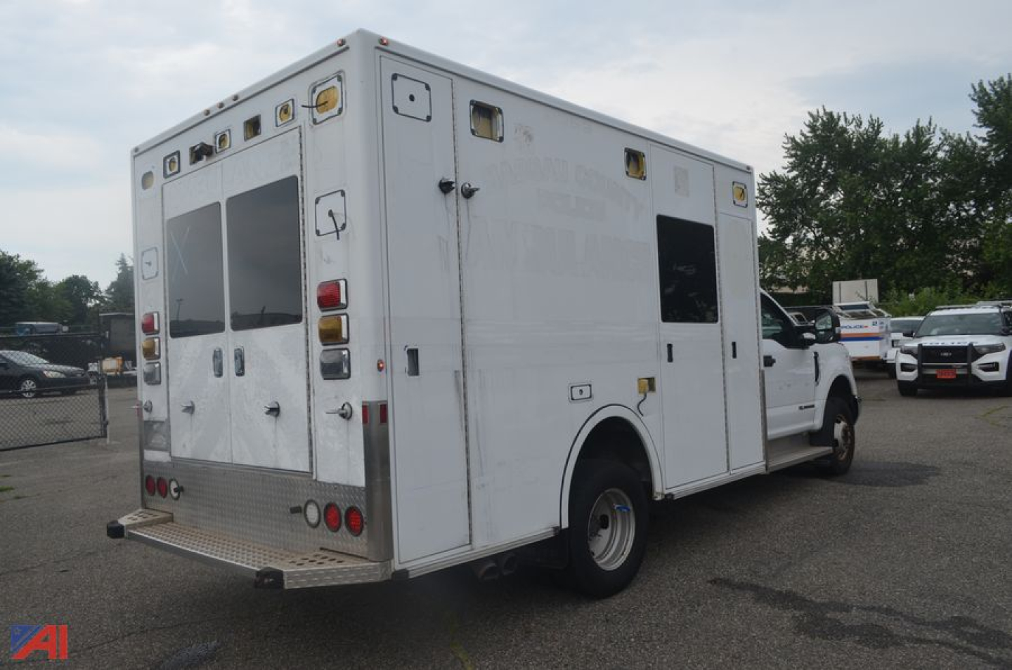 Ambulance box truck rear-right view showing exterior compartments and back doors