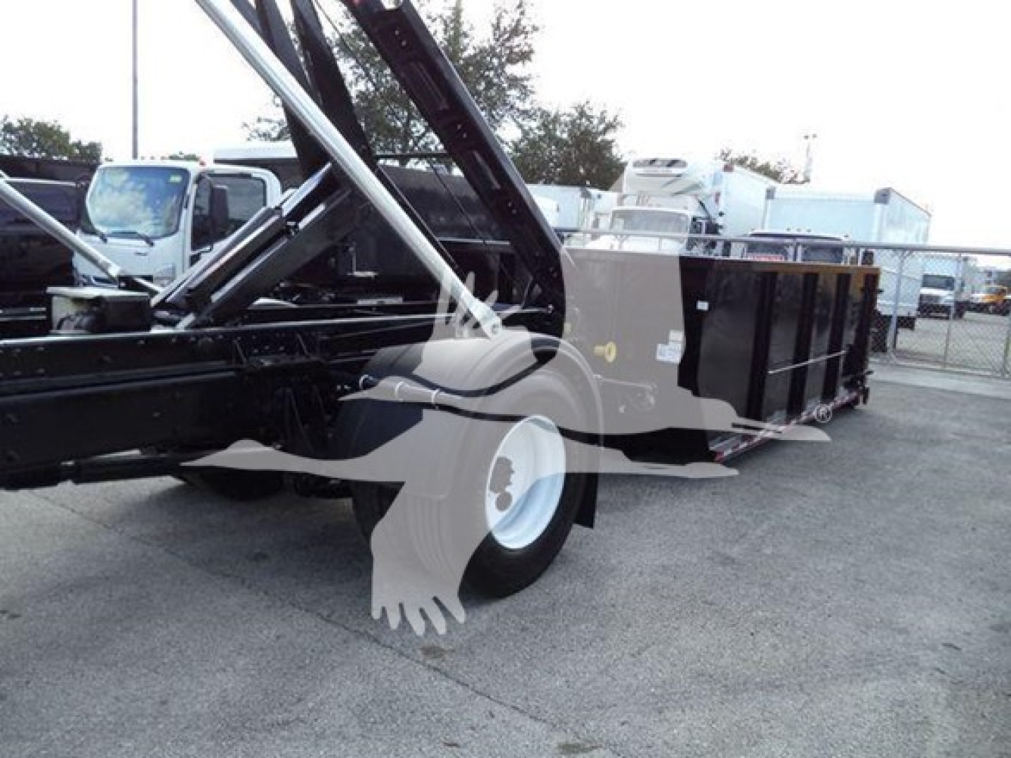 2019 International Durastar 4300 roll-off truck with bed loaded and hydraulics visible.