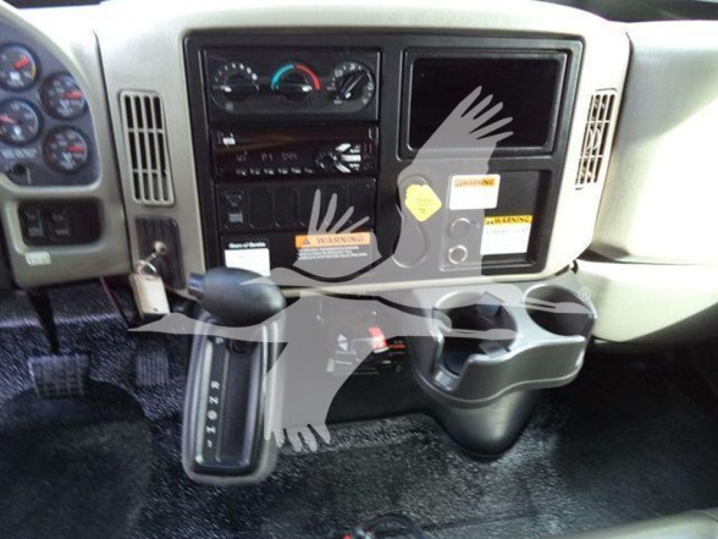 Dashboard view of a 2019 International Durastar 4300 cab with gear selector, control panels, and cup holders.