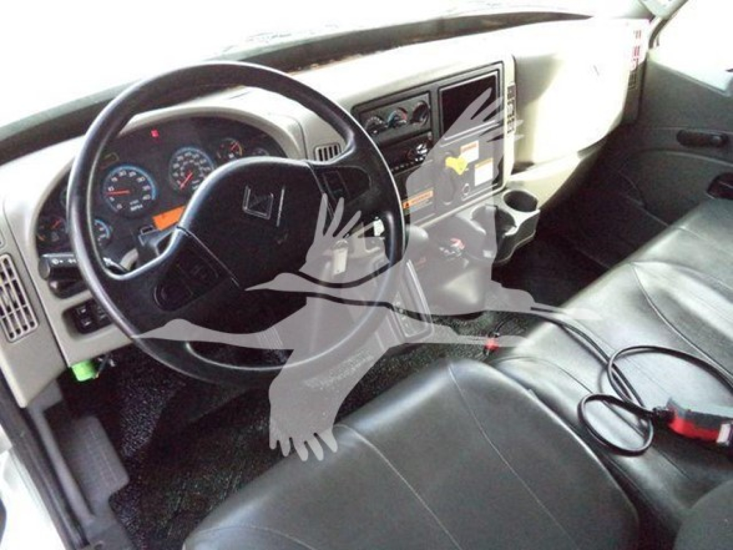 Interior of 2019 International Durastar 4300 cab showing steering wheel, dashboard gauges, center console, and driver's seat.