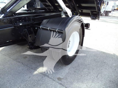 Truck rear wheel and roll-off body of a 2019 International Durastar 4300 showing spare tire, chassis components, and load bed area.