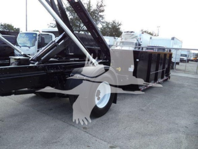 2019 International Durastar 4300 roll-off truck with bed loaded and hydraulics visible.