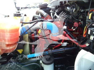 Trucks engine bay showing coolant reservoir, hoses, and various components in a 2019 International Durastar 4300.