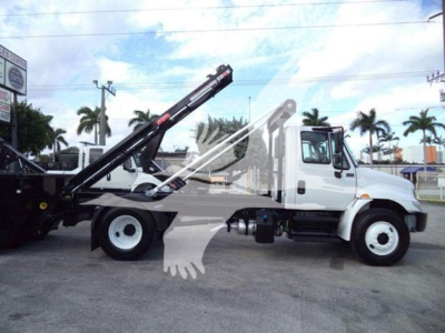 2019 International Durastar 4300 roll-off truck side view showing crane arm and hydraulic lift system.