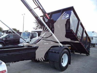 2019 International Durastar 4300 roll-off truck with tilted dump bed and crane arms visible, front chassis, single rear wheel, stock T15012.