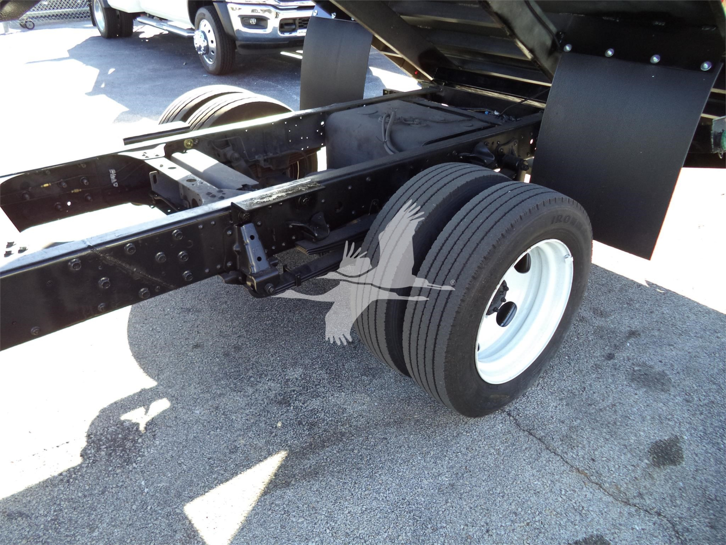 Isuzu NPRR truck chassis showing dual rear wheels and frame near suspension.