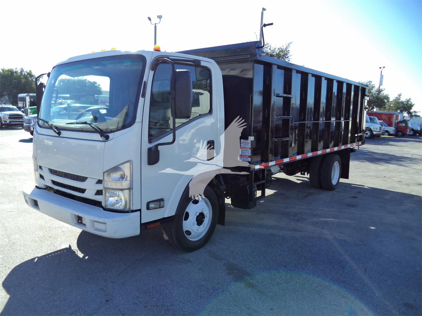 Isuzu NPRR dump truck in a used inventory lot