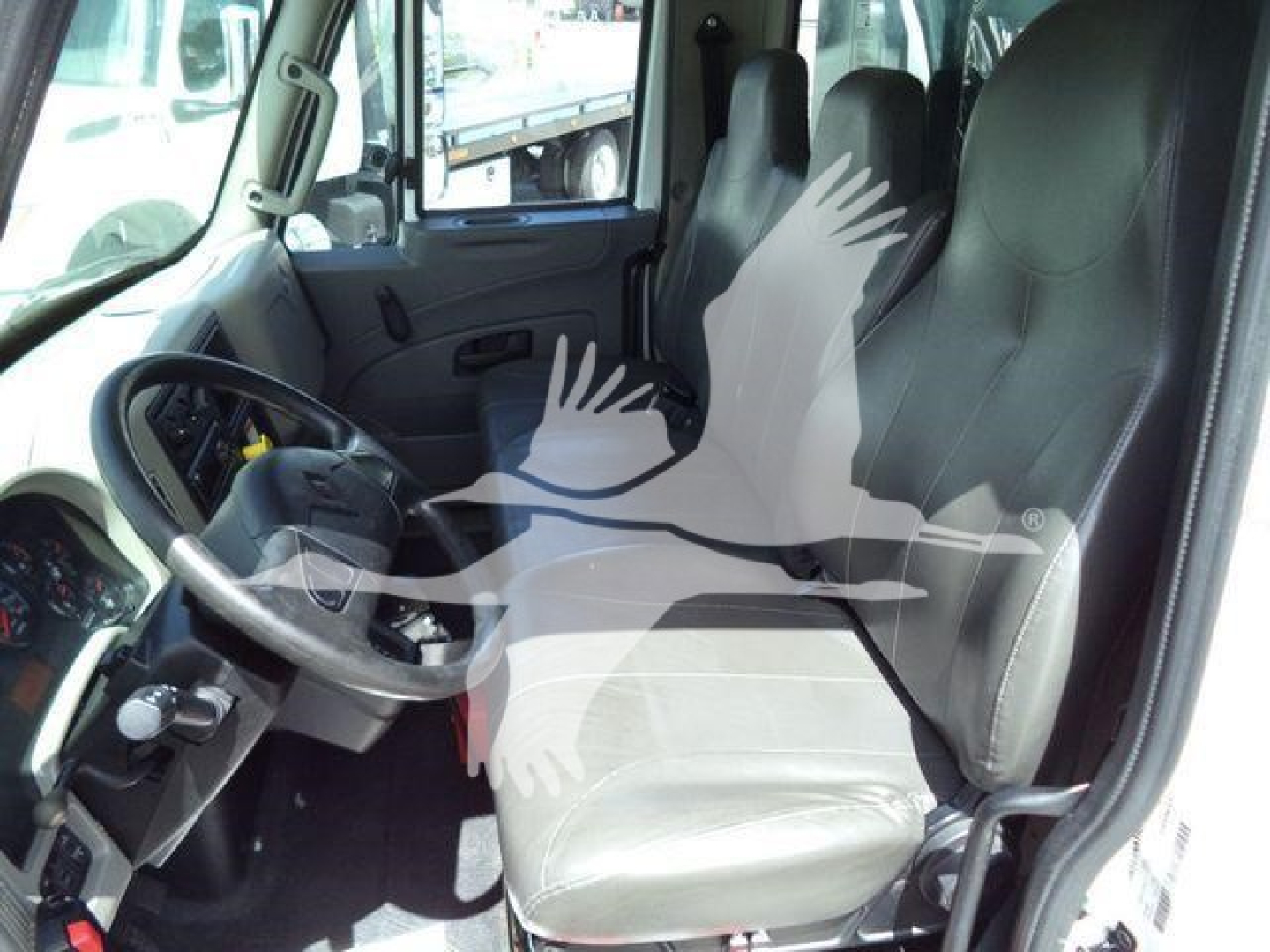 Interior of a 2019 International 4300 truck cab showing driver seat and steering wheel.