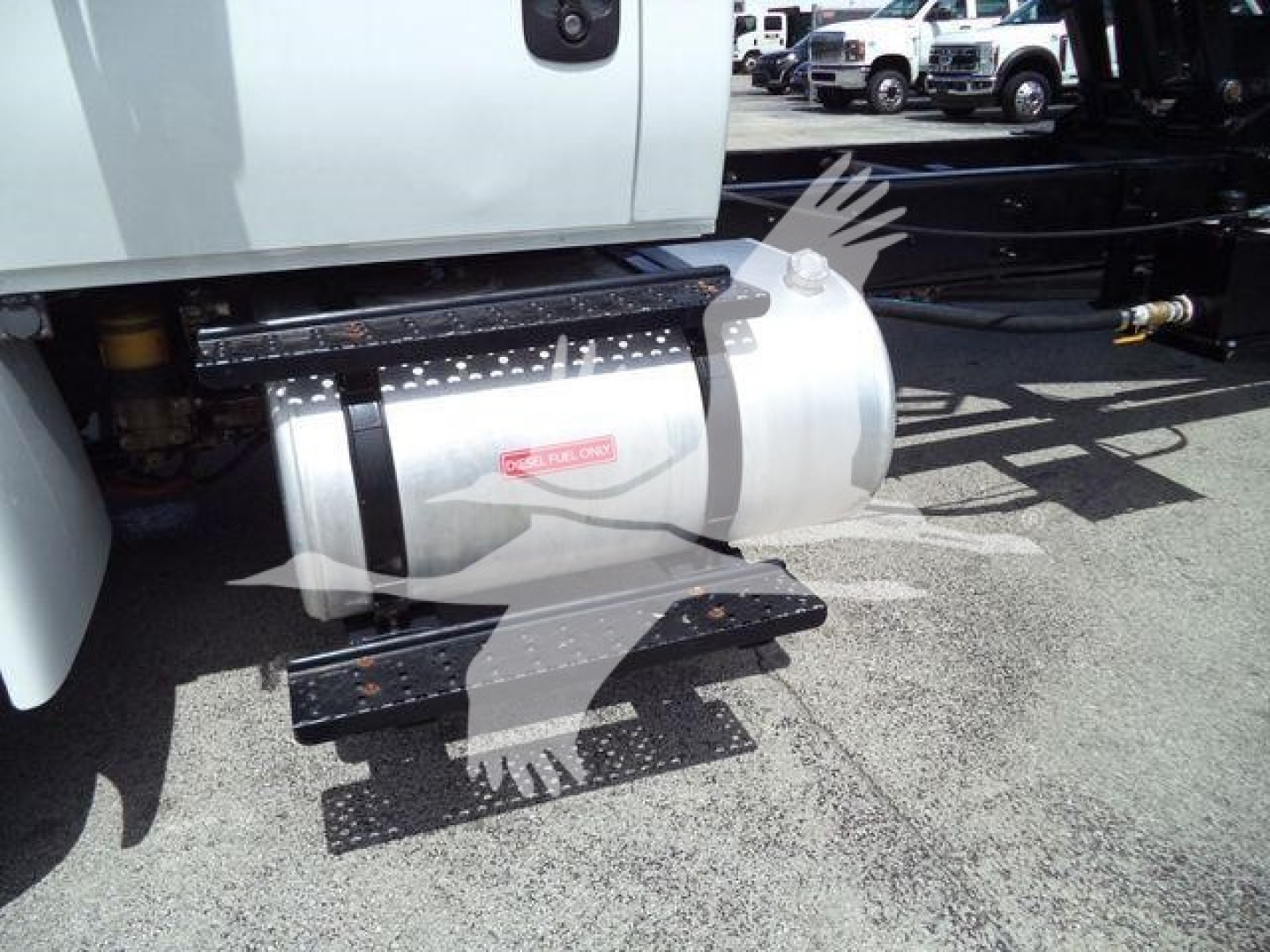 Truck side view showing fuel tank and underbody steps on a 2019 International 4300 dump truck.