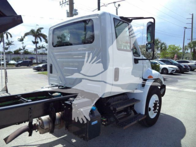 ICE/dual-rear-tire truck cab of a 2019 International 4300 dump truck showing cab, stepping, and chassis with engine bay area visible.