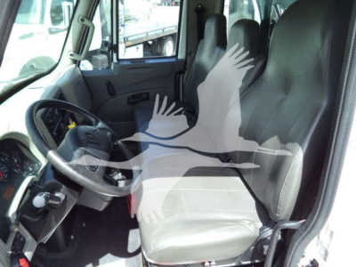 Interior of a 2019 International 4300 truck cab showing driver seat and steering wheel.