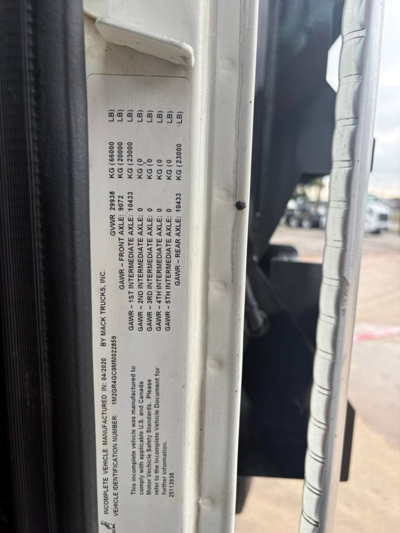 Vehicle label on Mack GR64F showing weight ratings and tire information in small print.