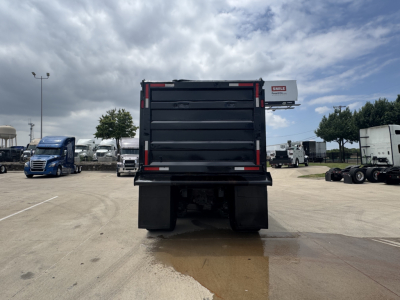 Dump truck bed rear view of a 2021 Mack GR64F showing the dump body and mud flaps.