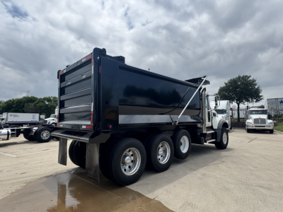 2021 Mack GR64F dump truck rear three-quarter view showing dump bed and dual rear axles with mud flaps.