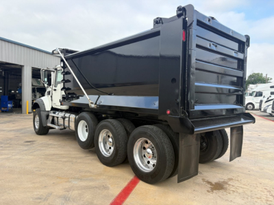 Dump truck with black dump bed showing rear and side view, dual rear wheels, Mack GR64F styling, white cab, stock number B3433P.