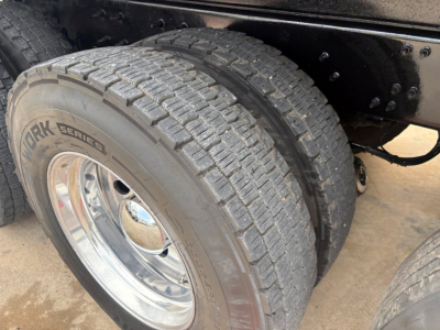 Rear dual rear axle showing York Series tire and chrome wheel on Mack GR64F dump truck chassis.