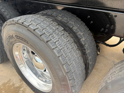 Truck rear dual tires with ribbed tread showing Yokohama? No, shows York? The tire reads YORK SEM? Actually visible text: YORK SERE? The wheel shows chrome rim and black frame. Sidewall of tire shows 'WORK SERIES' maybe 'WORK SERIES' and ot