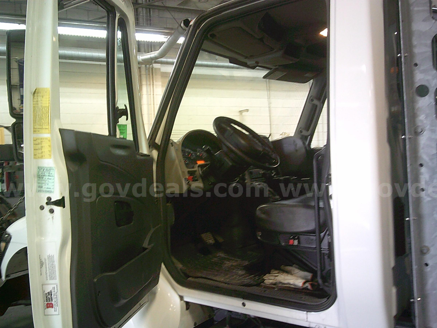 Cab interior of a 2011 International WorkStar 7400 dump truck showing driver’s seat and dash