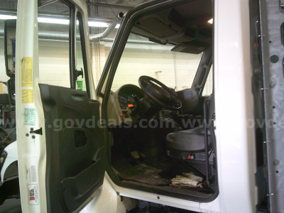 Cab interior of a 2011 International WorkStar 7400 dump truck showing driver’s seat and dash