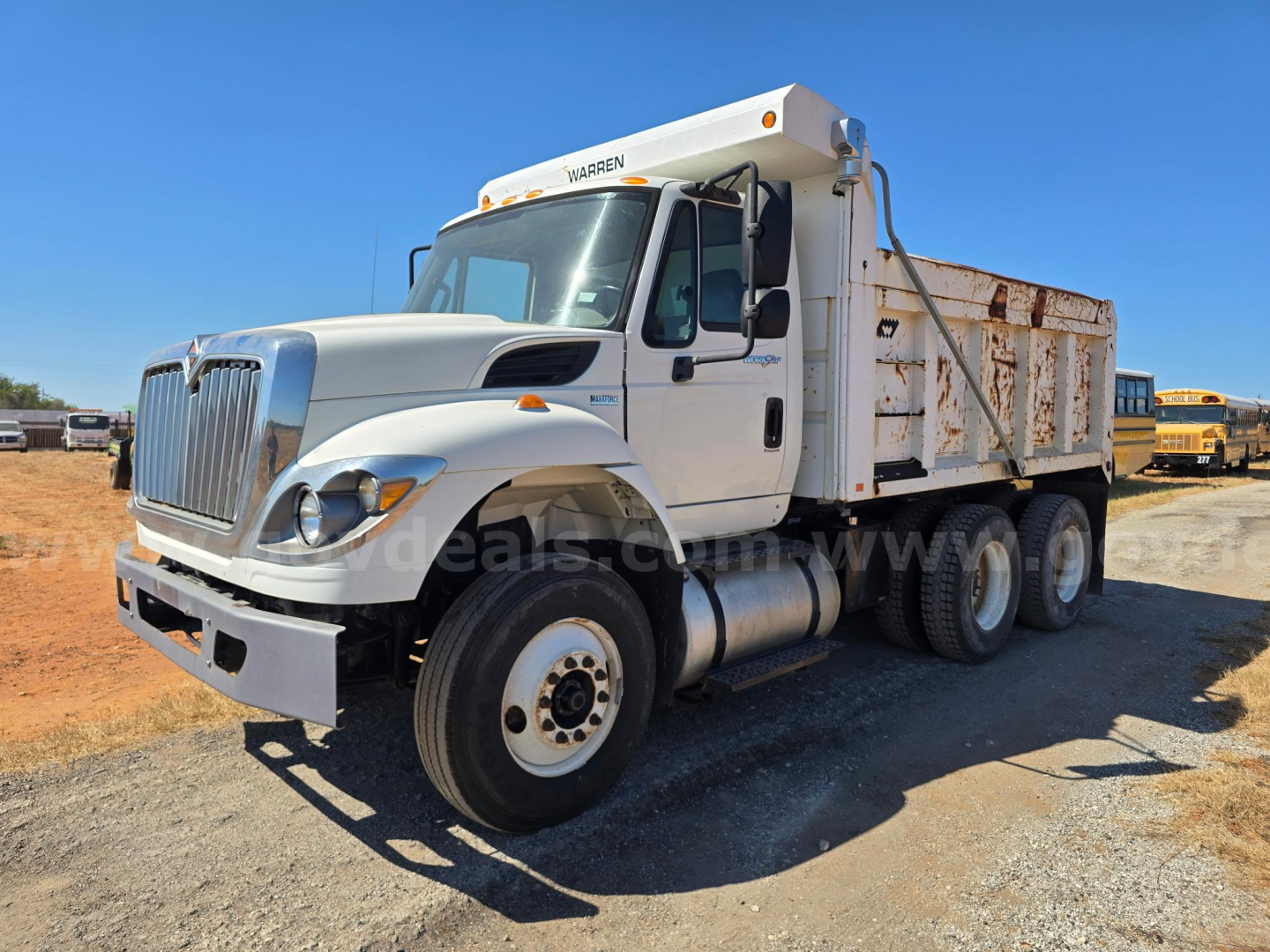 Truck dump bed chassis visible with International 7400 cab; text on the cab shows WARNER on top of the cab; no other legible labels visible.