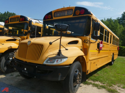 School bus showing front and side, yellow International CE 3000 with School Bus sign and stop arm visible.