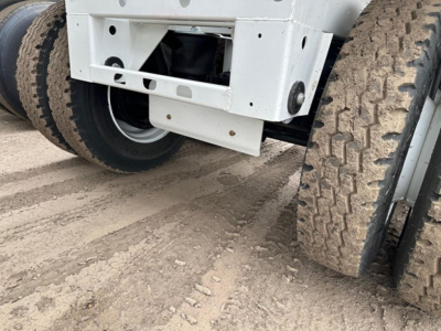 Bottom dump trailer rear view showing dual rear tires and undercarriage frame