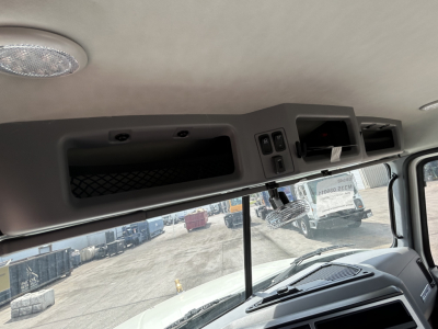 Mack GR64B cab interior showing overhead compartments and dash area with window view