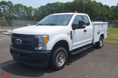 Ford F-250 Super Duty utility truck, extended cab, white, service body with side storage compartments, front grille and bumper visible