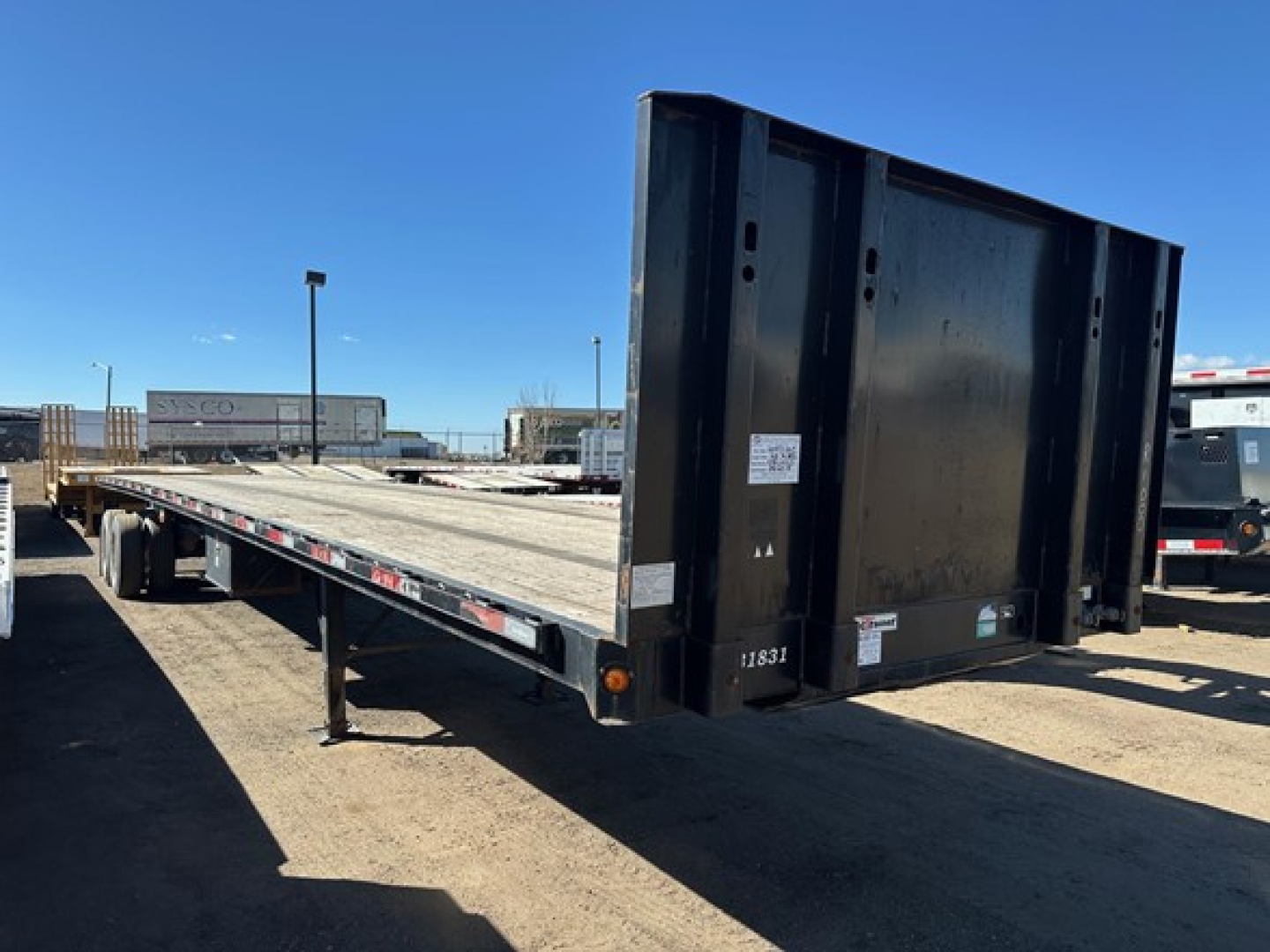 Flatbed trailer with forklift kit mounting area showing steel frame and tail; VIN 150119763322 stock UE11423 category flatbed type trailers used status.
