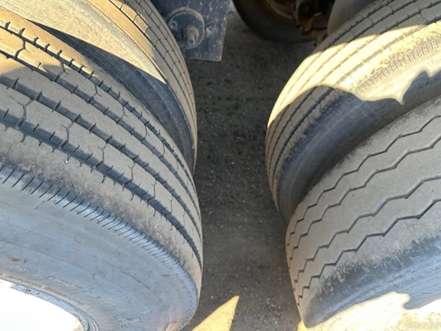 Wheel tires of a flatbed trailer seen from above.