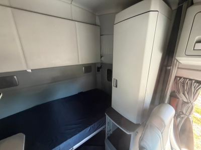 Kenworth T680 sleeper cab interior showing bunk area and overhead storage