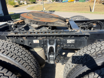 Kenworth T680 tractor truck frame and fifth-wheel connection showing chassis, dual rear axles, and part of the hitch area.