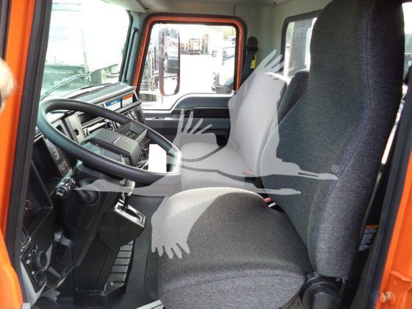 Cab interior of a 2026 Mack MD6 truck showing driver seat and dashboard with steering wheel and controls.