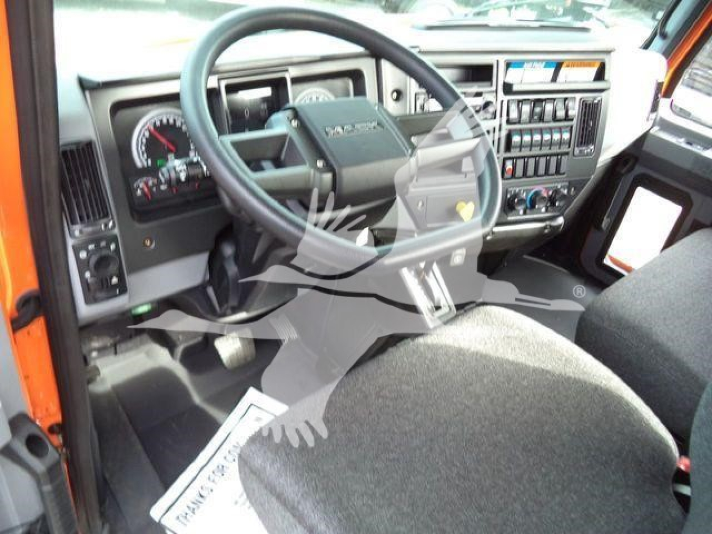 MD6 dashboard and steering wheel view inside cab showing instrument cluster and center control panel.
