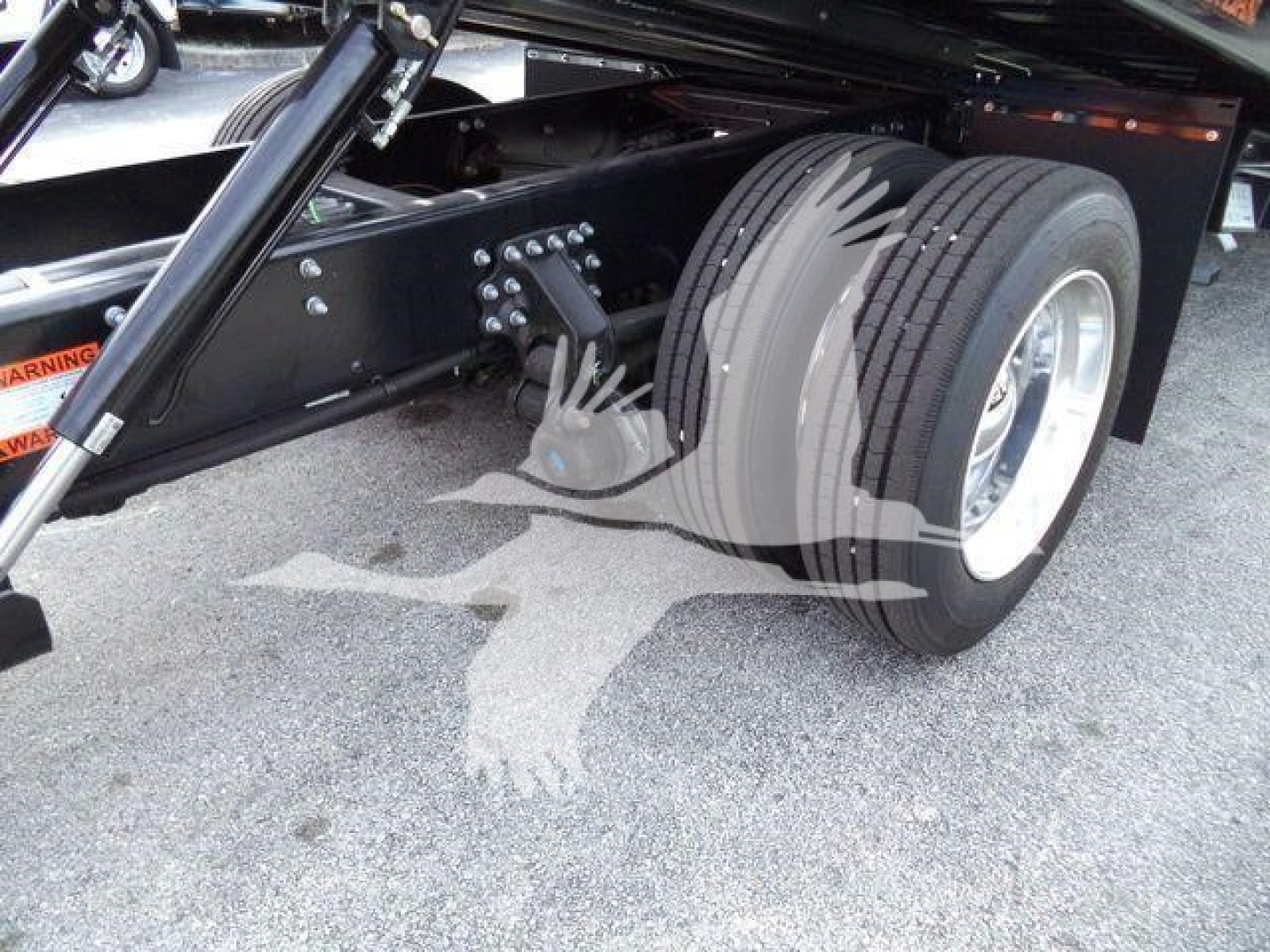 Mack MD6 truck chassis showing dual rear wheels and suspension components.