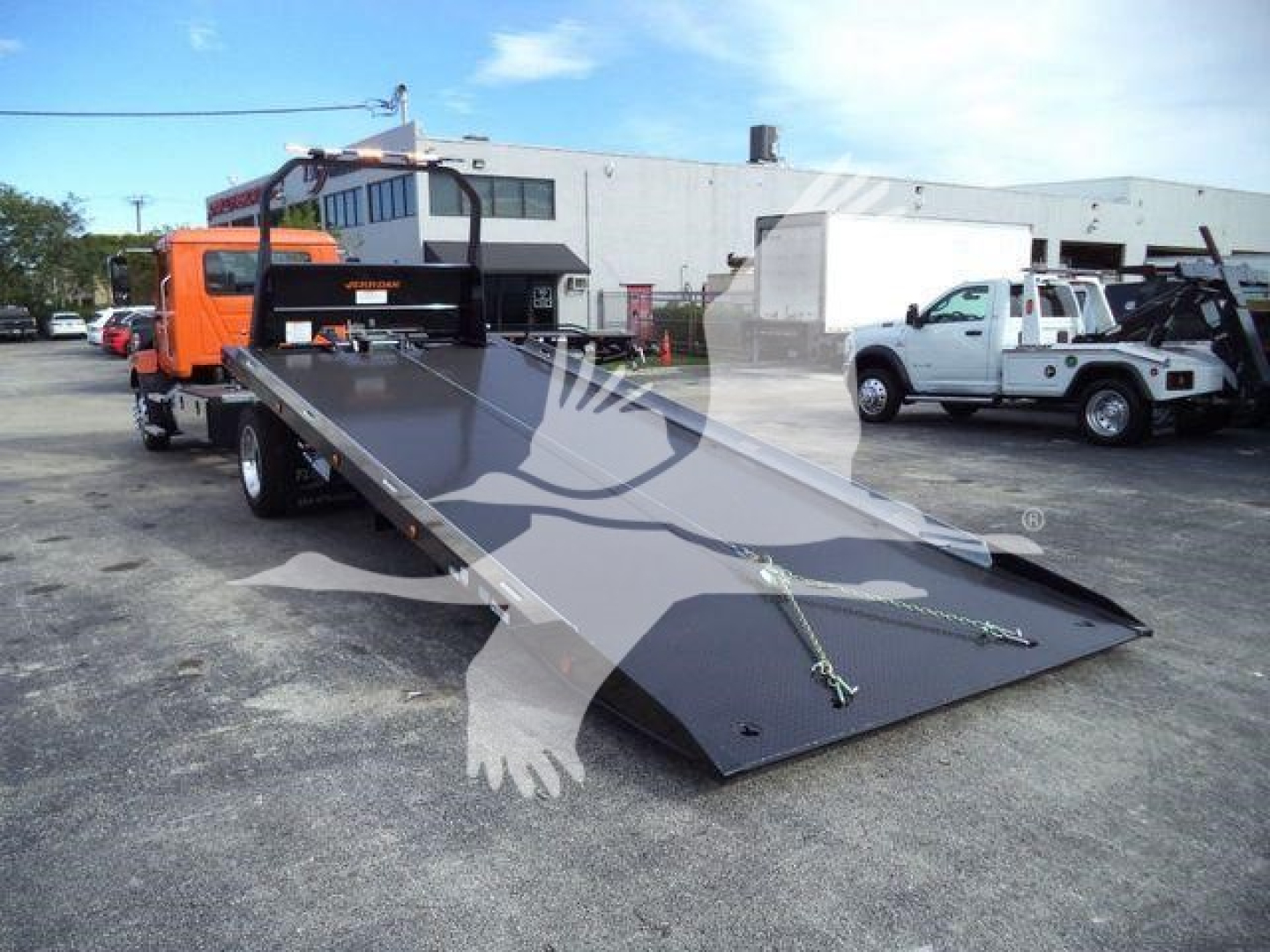 MD6 rollback truck with a lowered flatbed/rollback ramp.