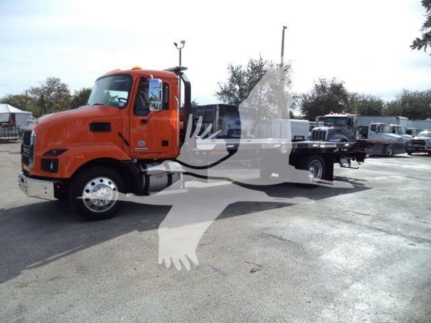 MD6 rollback truck with orange cab and flatbed side view showing basic exterior features.