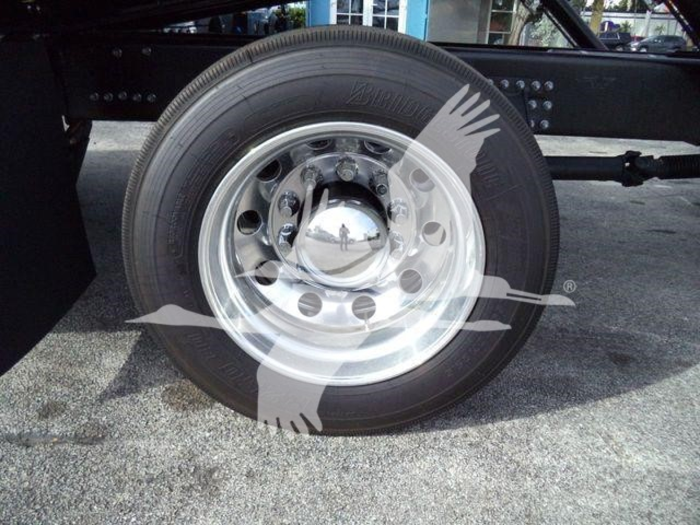 Wheel on Mack Md6 showing tire and polished steel hub with lug nuts and chrome center cap; no visible text readable besides tire tread