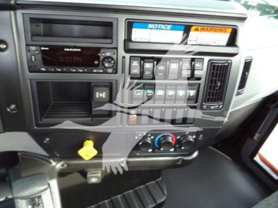 Dashboard of a 2026 Mack MD6 truck showing radio, control panel, warning labels, and HVAC controls.