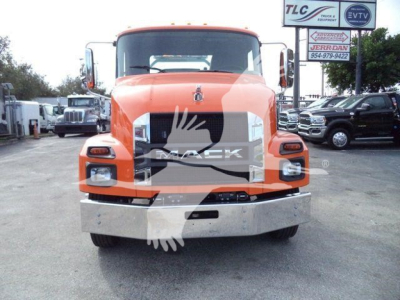 Mack MD6 rollback truck front view showing orange cab, large grille, square headlights, and chrome bumper.